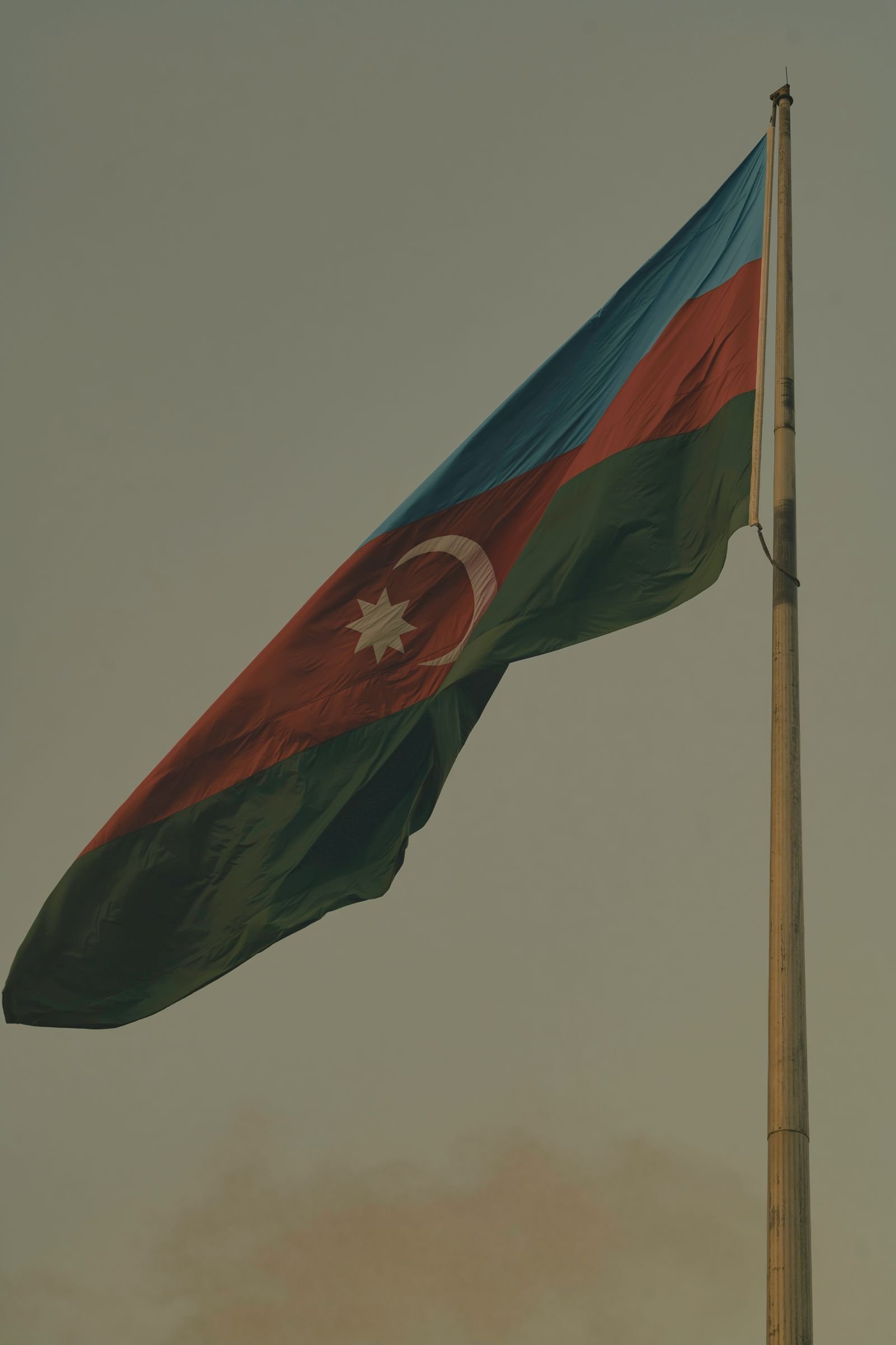 The Azerbaijani flag flying at dusk